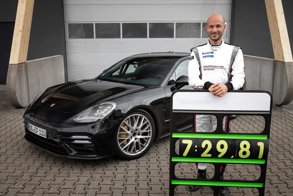 Testovací pilot Lars Kern s tabulí zobrazující jeho rekordní čas na Severní smyčce na Nürburgringu